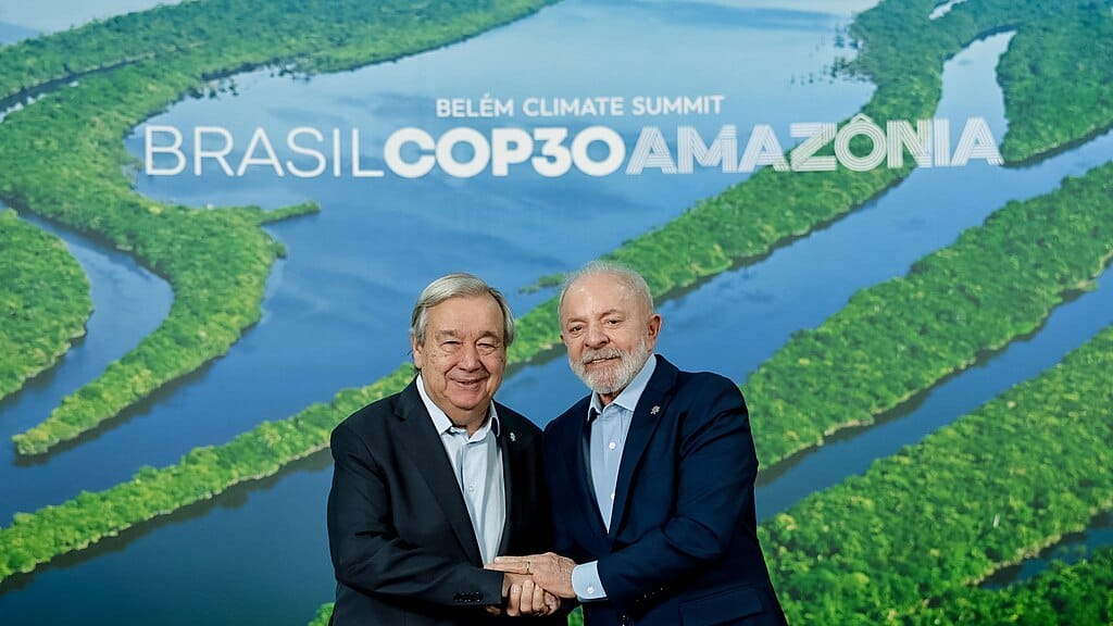 Brazil's president Lula and UN secretary-general Guterres in front of a sign for COP30