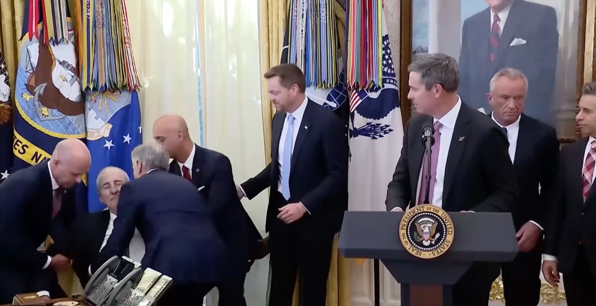 A man on the left falls to the floor while several others including Dr. Oz help him and others look on inside the Oval Office, and RFK Jr heads to the exit in a hurry